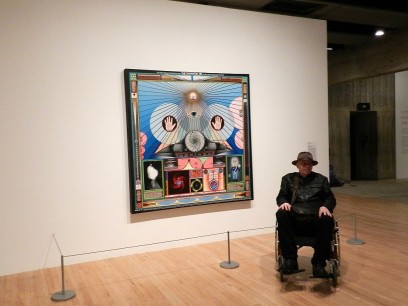 Artist Paul Laffoley in front of his work Thanaton III. The painting illustrates the third visitation of an alien, who appears to Laffoley in a humanoid form as a one-metre-high reptilian-featured hermaphrodite that speaks to him telepathically