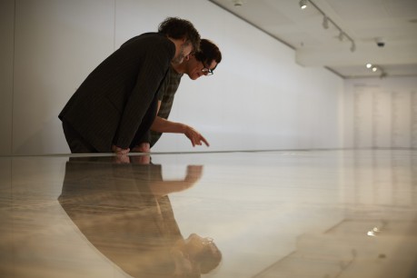 Jarvis Cocker and Cornelia Parker look for his phrase 'Common People' on Magna Carta (An Embroidery. Photograph by Joseph Turp.