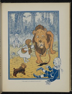 Toto looks on with some interest as Dorothy talks to the cowardly Lion, The Wonderful Wizard of Oz
